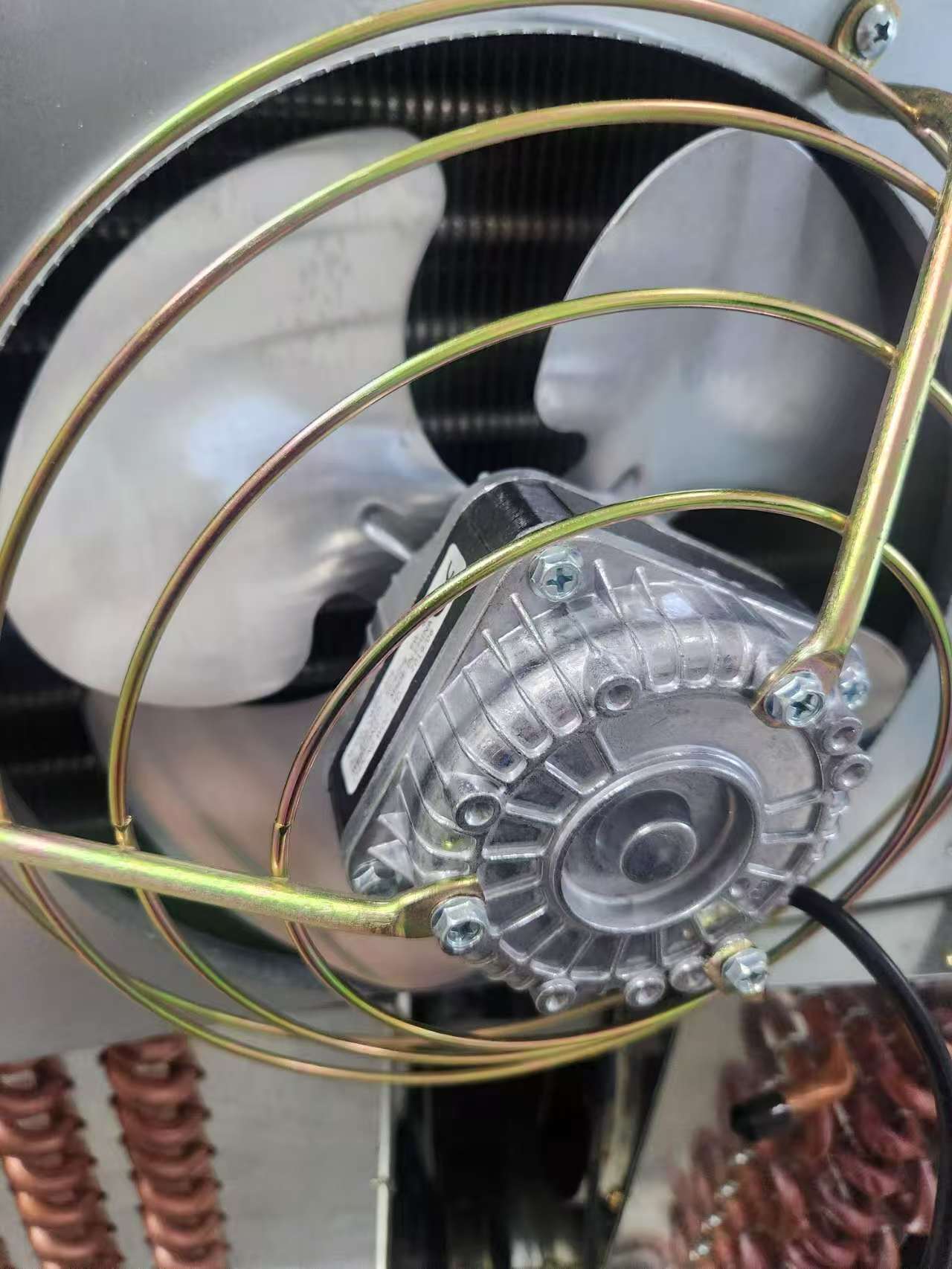 Installation of locking fan motor mounting screws on an axial motor guard