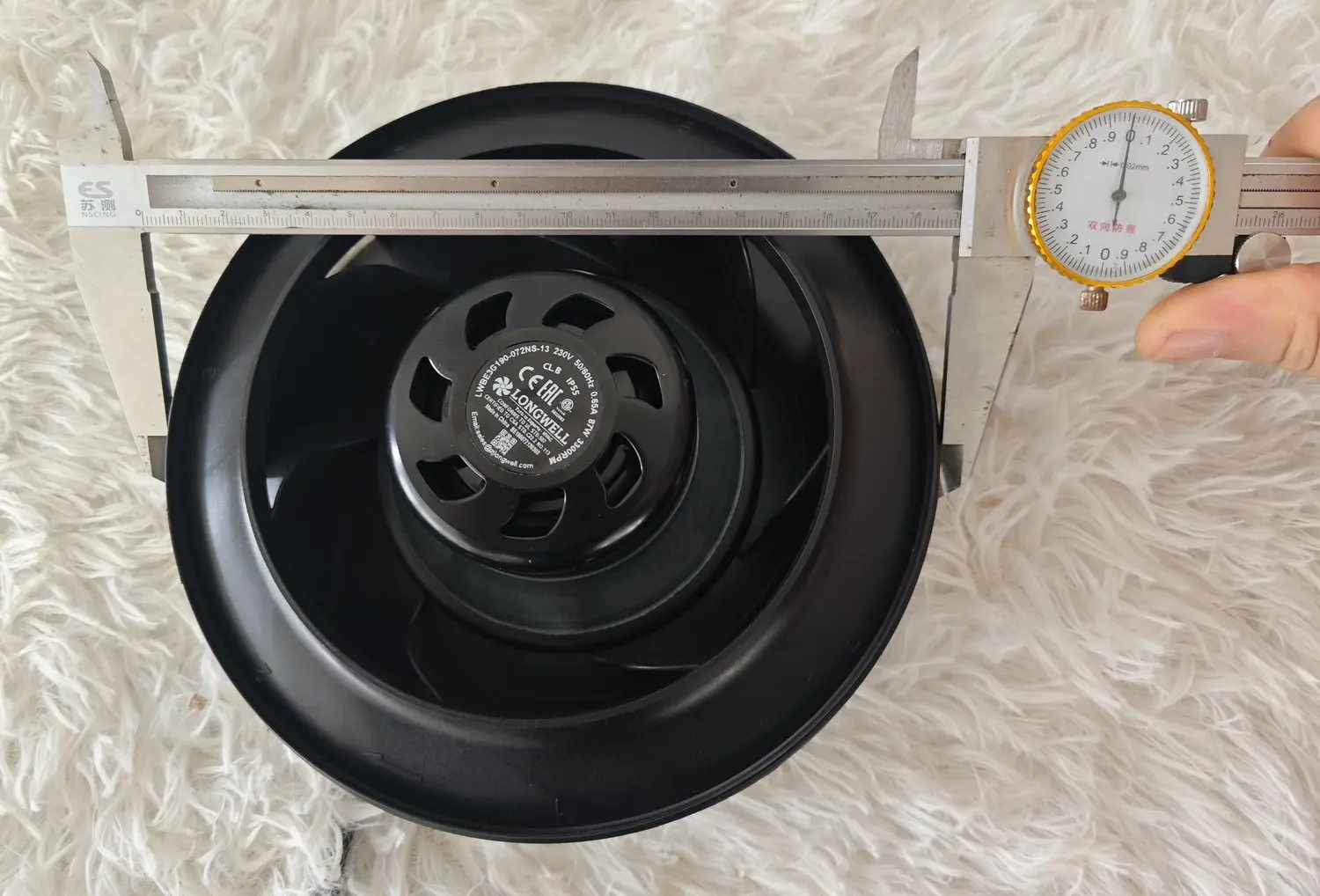 Backward-curved EC impeller measured with a dial caliper, nameplate reading LWBE3G190-072NS-13