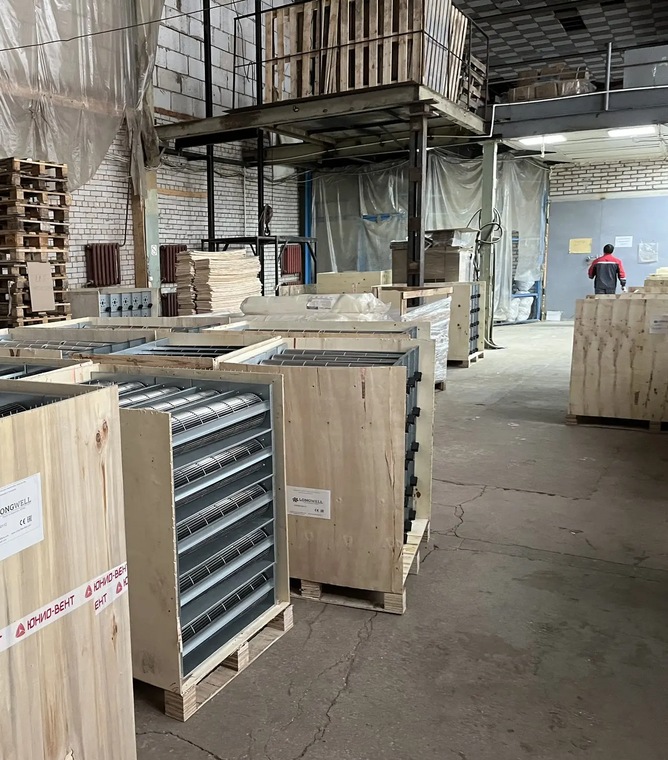 Crated long cross-flow fan assemblies on pallets with LONGWELL shipping labels