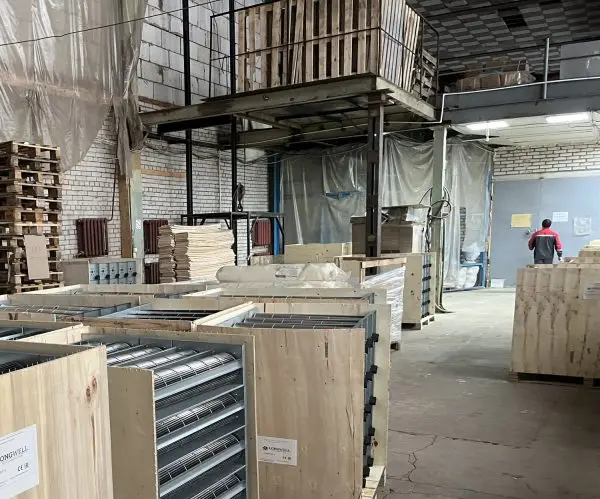 Customer warehouse, brick-built: several crates of long cross-flow assemblies with LONGWELL marks carrying CE and E
