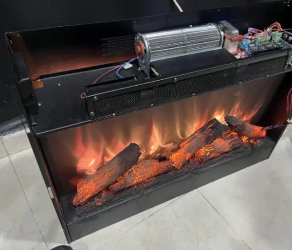 An electric fireplace running on the customer s bench with its flame effect lit