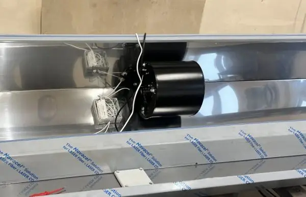 A centrifugal blower fitted into a stainless air-curtain housing on the customer s assembly line, protective film s