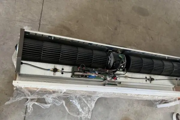 The same class of unit opened up: two cross-flow barrels driven from a shared centre motor, the control board and t