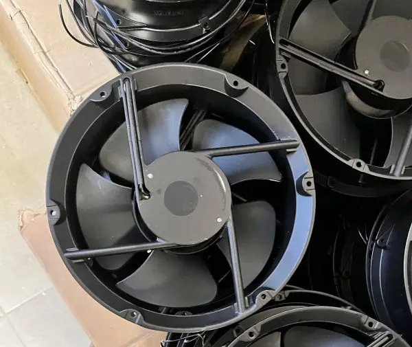 Round-frame axial fans five sickle-shaped blades on a large external-rotor hub, with loose lead wires and a wire fi