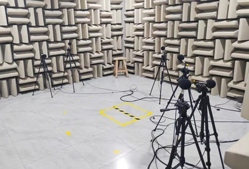 Acoustic test room with microphones and measurement stands; facility context, not a test of the fan in this article