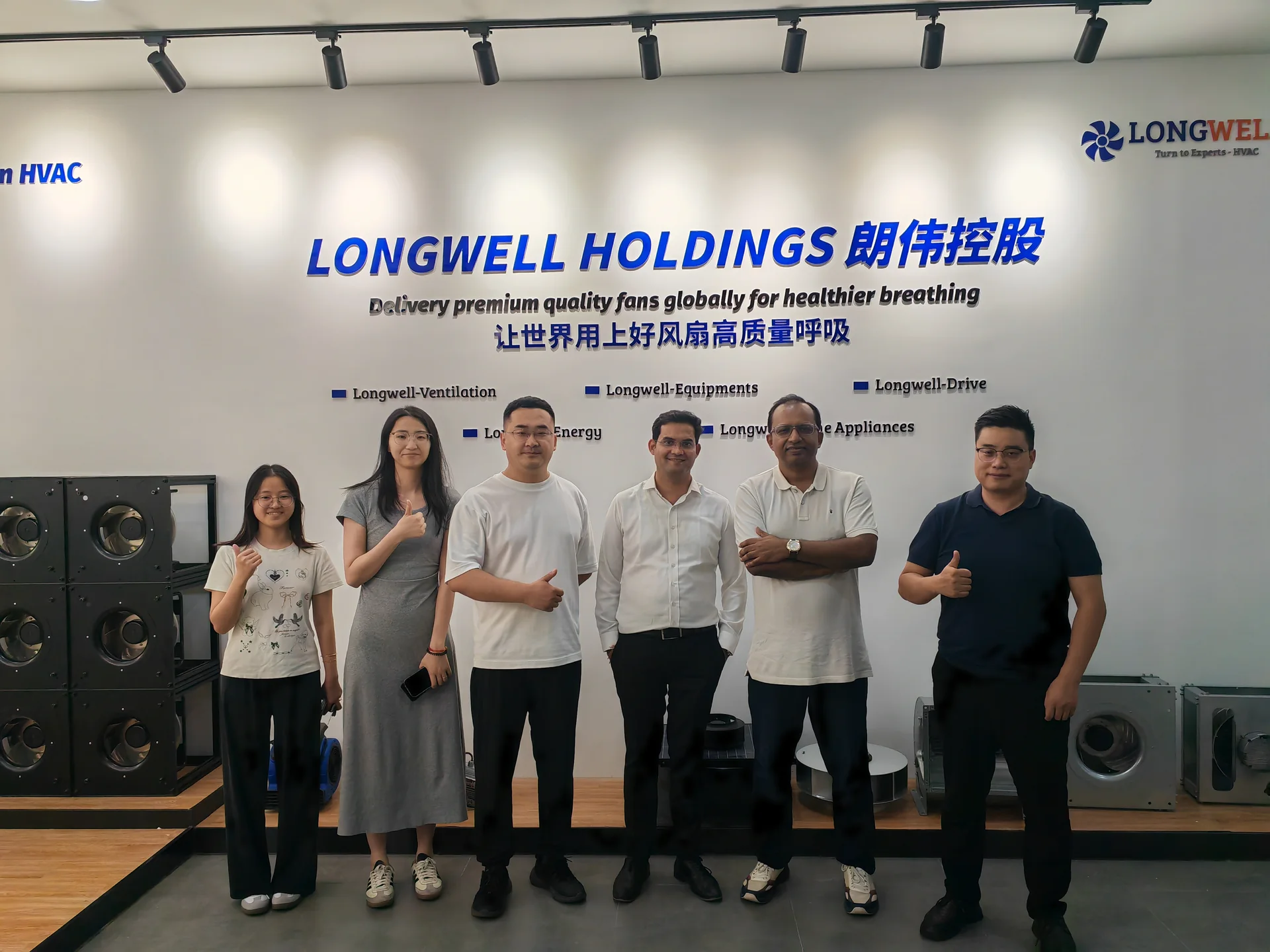 International visitors photographed inside LONGWELL’s showroom and reception space.