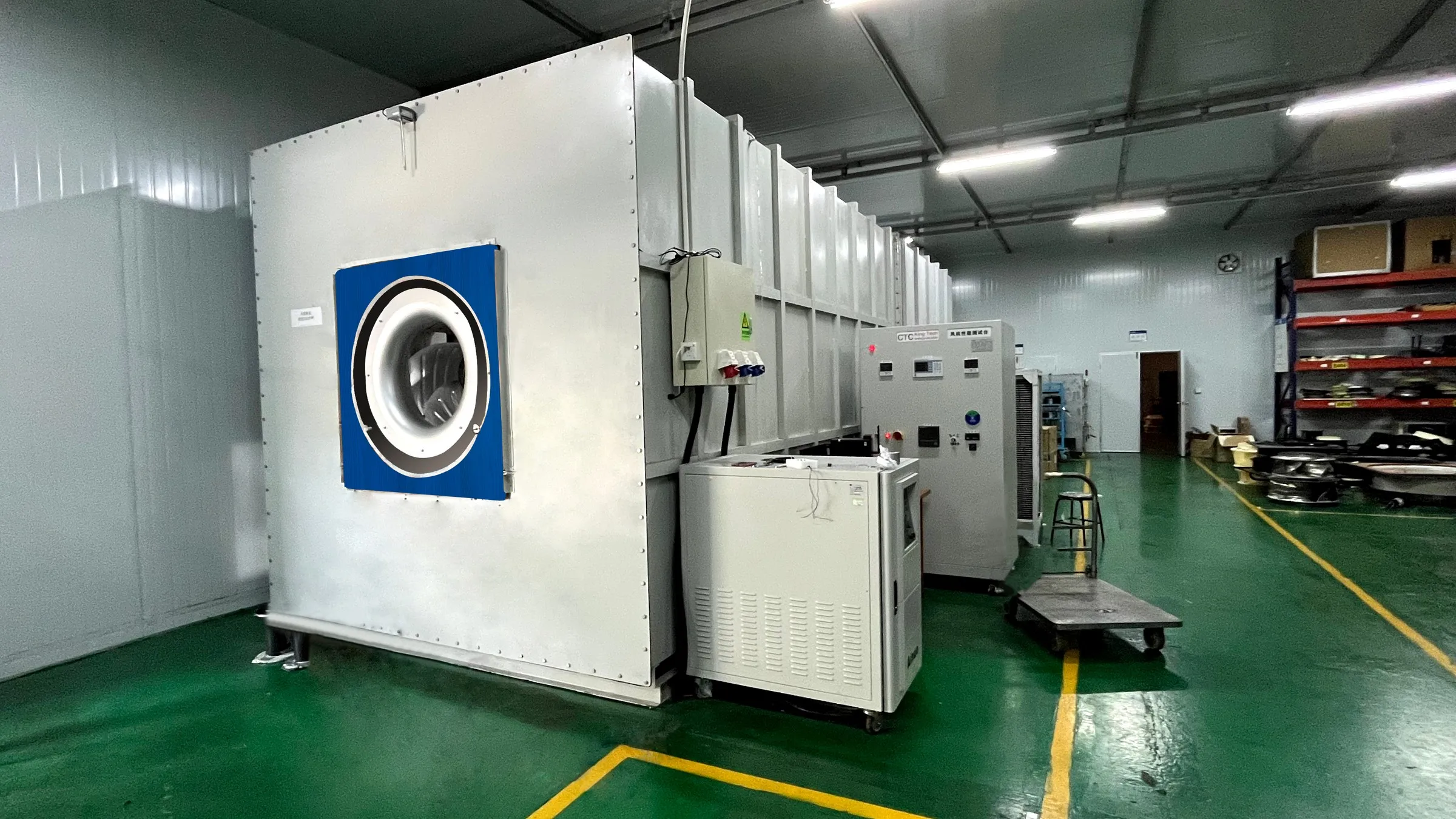 LONGWELL fan test facility photograph showing a fan at the opening of a large enclosed test apparatus; no measurement result is visible