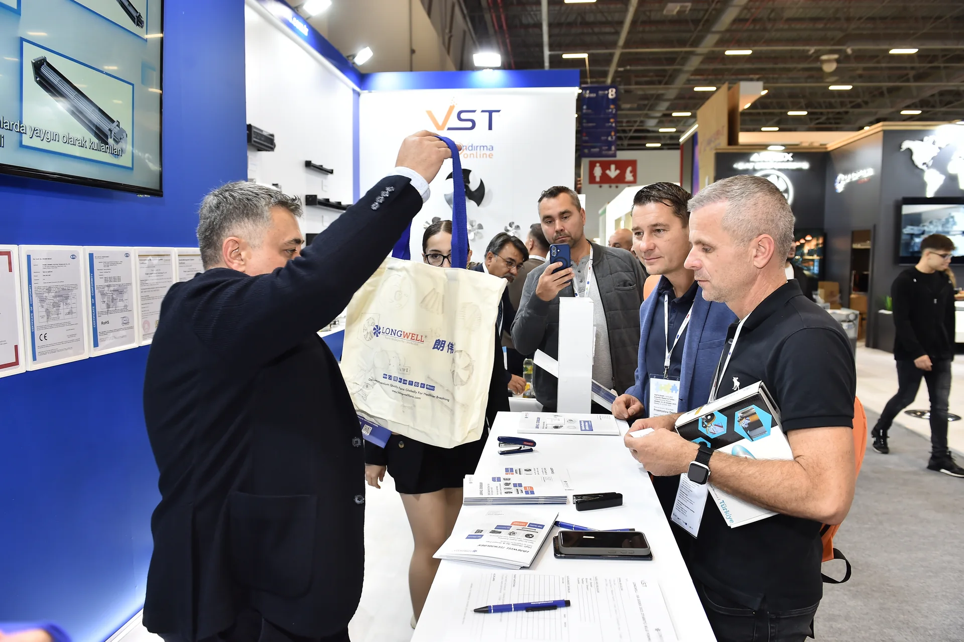 Face-to-face engagement at the LONGWELL and VST booth.