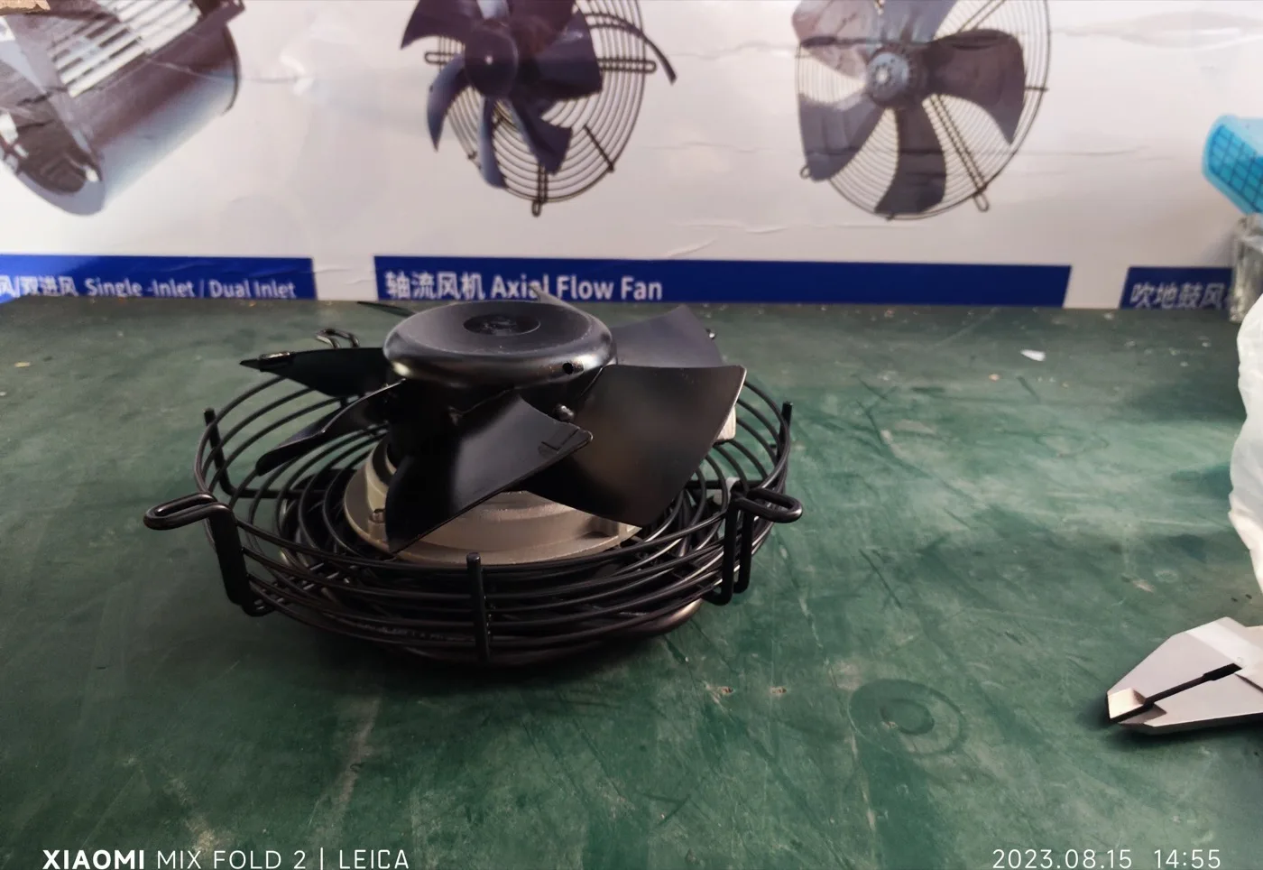 LONGWELL AC axial fan sample with wire guard on the production bench