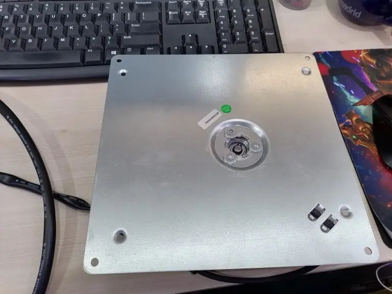 Reverse of the custom-tooled metal mounting plate with QC PASS mark and batch serial