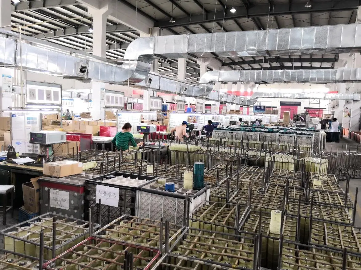 LONGWELL factory floor with racks of motor stators, assembly stations and balancing test benches